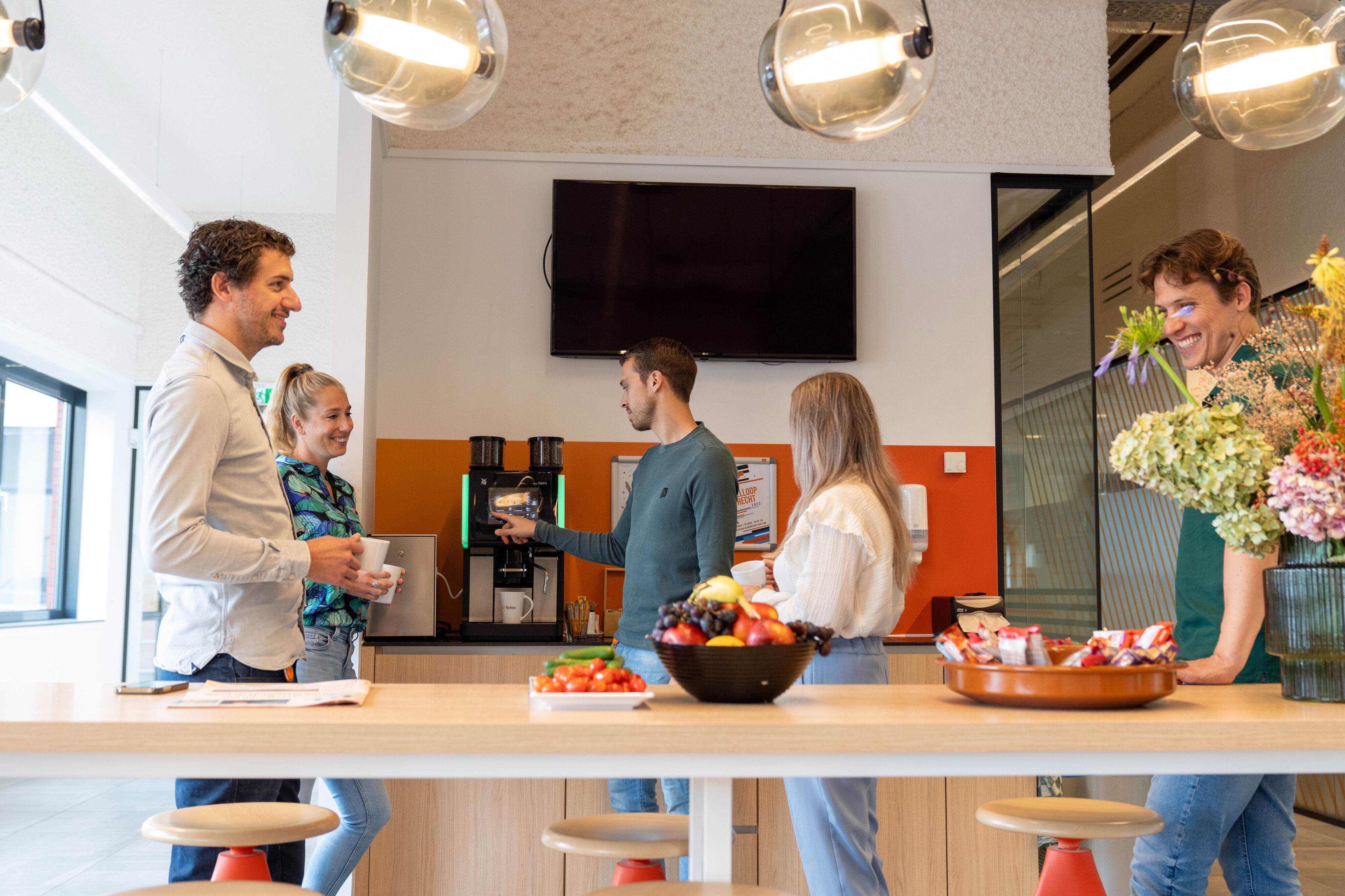 Enjoying coffee and snacks during a break at Keylane's vibrant office environment. Collaborative team atmosphere fostering innovation and growth in the insurance tech sector.