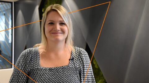 Building a diverse and innovative team for Keylane careers, showcasing a professional woman smiling in a modern office environment, emphasizing career growth and opportunities at Keylane.