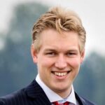 A smiling young professional in business attire representing career opportunities at Keylane, emphasizing innovation, growth, and a dynamic work environment.